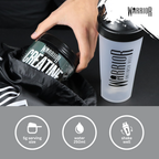 Warrior Creatine Monohydrate tub pulled from a gym bag next to a shaker with serving and mixing instructions
