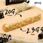 Warrior Crunch Protein Bar Salted Caramel cross-section with milk chocolate coating and caramel core under Triple Layered
