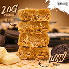 Cross-section stack of Cookies & Cream RAW bar pieces showing visible oats, white chocolate chunks and Oreo cookies, with 20G Protein and Low Sugar callouts