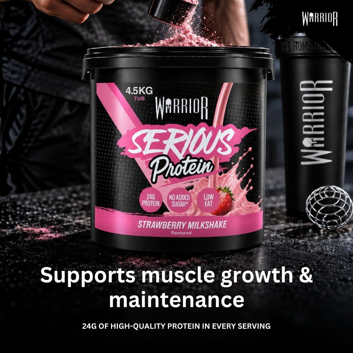 A large black tub of Warrior Serious Protein in Strawberry Milkshake flavor stands on a dark surface with pink powder being poured into it. A black shaker bottle and a metal scoop are placed beside it, with a person's hand and torso partially visible in the background.