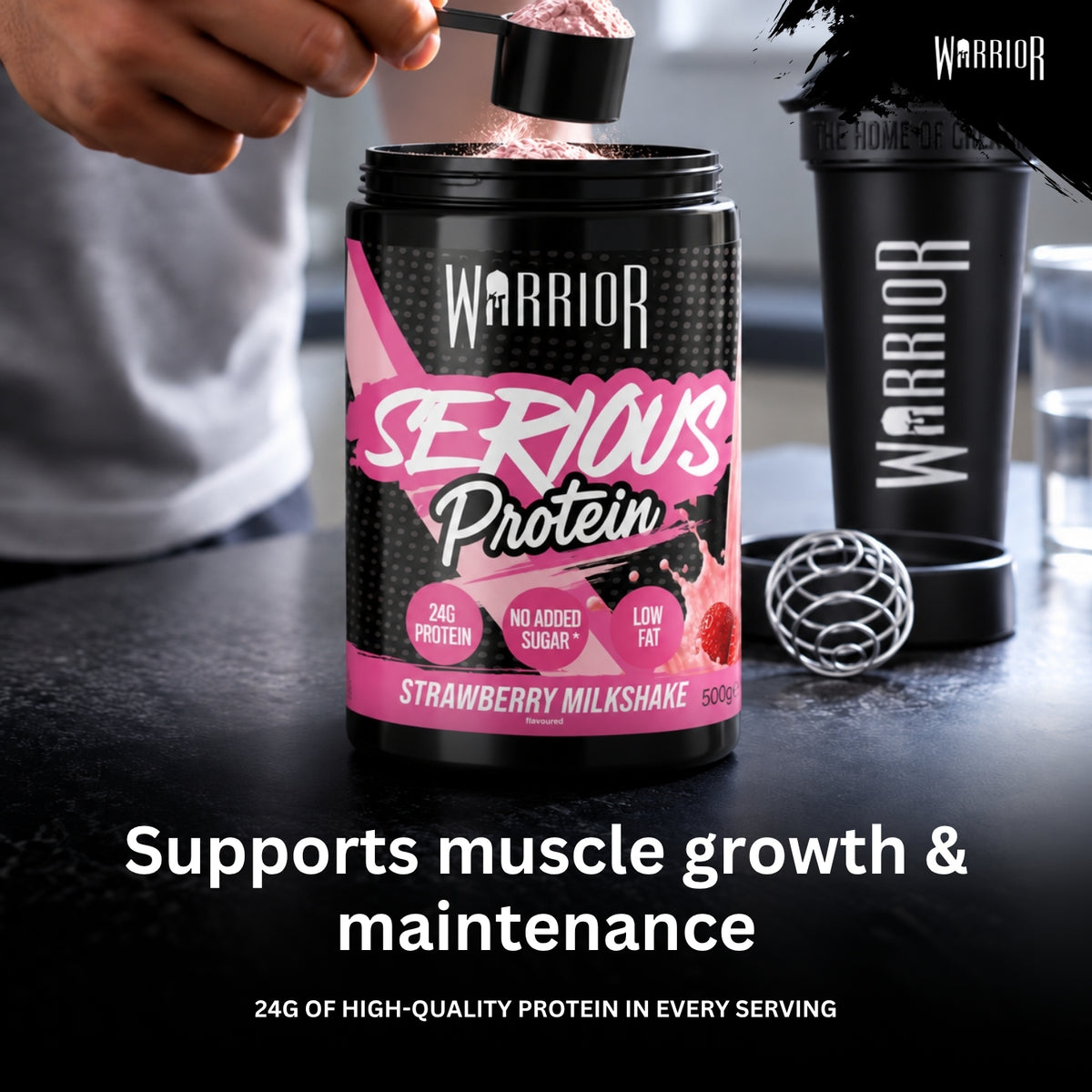 A person's hand is shown adding a scoop of powder into a black tub of Warrior Serious Protein Strawberry Milkshake. A matching black Warrior shaker bottle and a metal mixing ball sit on a dark countertop, with text below reading 'Supports muscle growth & maintenance' and '24g of high-quality protein in every serving'.