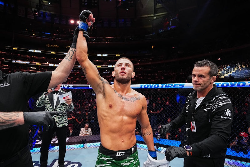 Oban Elliott with his arm raised in the UFC octagon