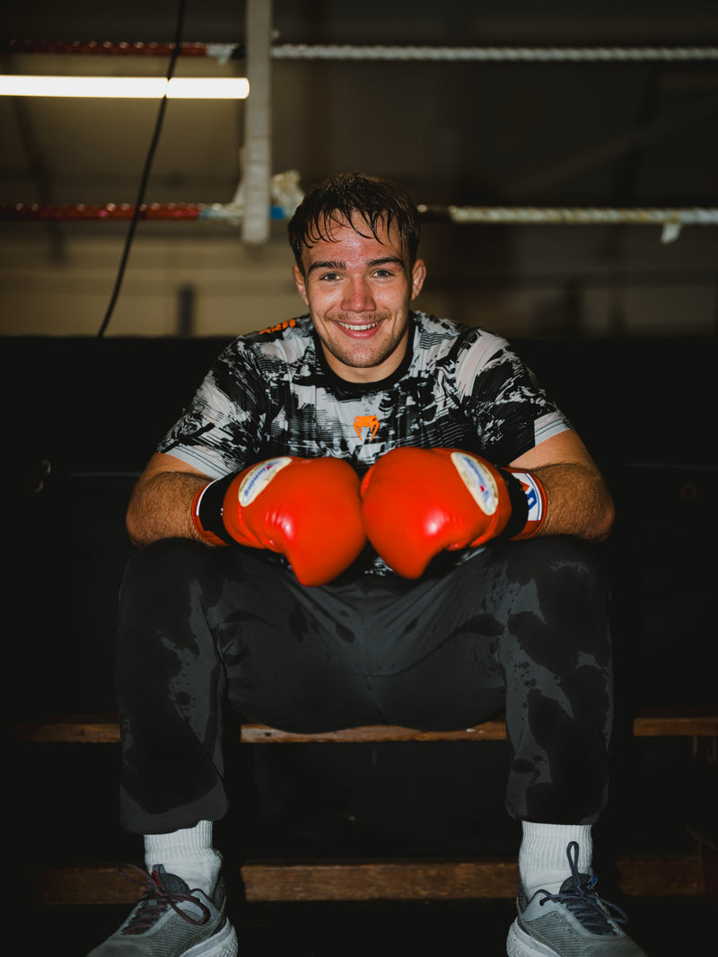 Shay Ingram in the gym wearing red boxing gloves