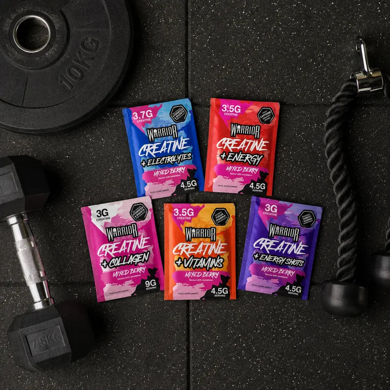 Warrior Creatine + Energy sachets in Mixed Berry flavour displayed with fresh berries. The packaging highlights 3.5g creatine and high caffeine content, showing 15-pack retail box design for performance and energy boost.